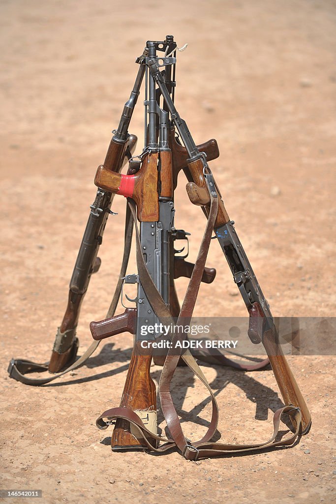 AK-47 rifles are stacked on a shooting range during a shooting course ...