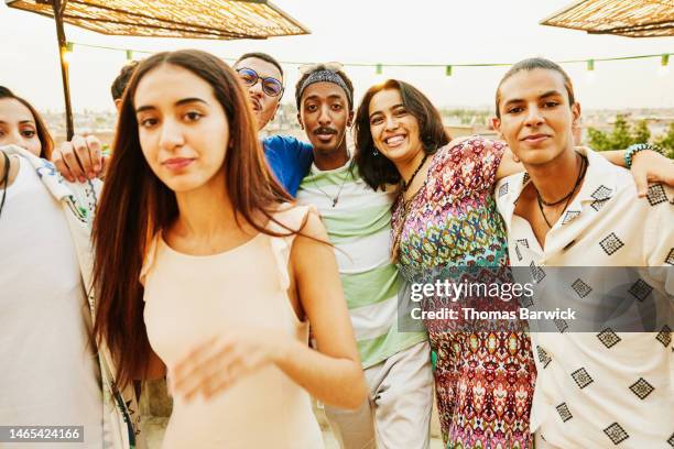 medium shot portrait smiling friends hanging out at rooftop restaurant - arab community life stock-fotos und bilder