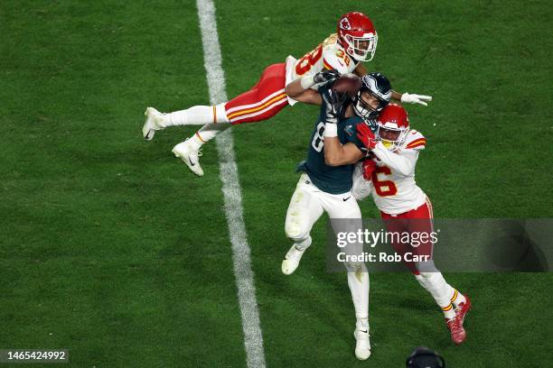 Dallas Goedert of the Philadelphia Eagles reaches for a catch against L'Jarius Sneed of the Kansas City Chiefs and Bryan Cook of the Kansas City...