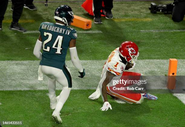 Jerick McKinnon of the Kansas City Chiefs slides short of the end zone to stop the clock against James Bradberry of the Philadelphia Eagles during...