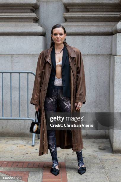 Tove Lo wears brown coat, cut out top, black blazer, leggings, bagoutside Puppets & Puppets during New York Fashion Week on February 12, 2023 in New...