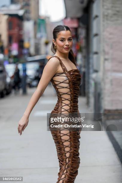 Tessa Brooks wears brown bounded leather dress outside Bronx & Banco during New York Fashion Week on February 12, 2023 in New York City.