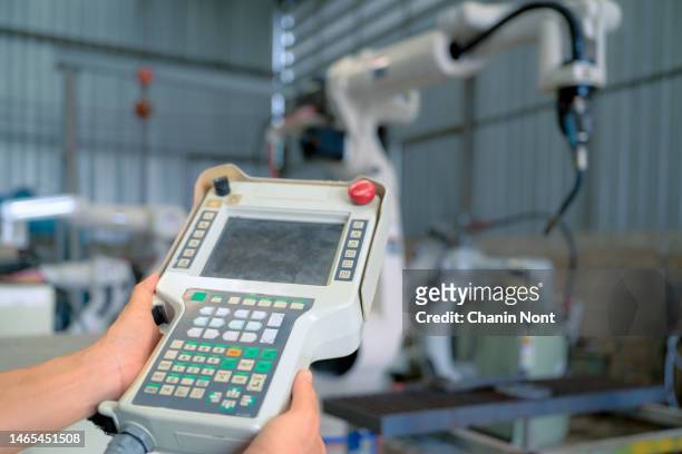 engineer programming robot in robotic by use coding for control positioning of robot to work in process. - positioning welding stock pictures, royalty-free photos & images