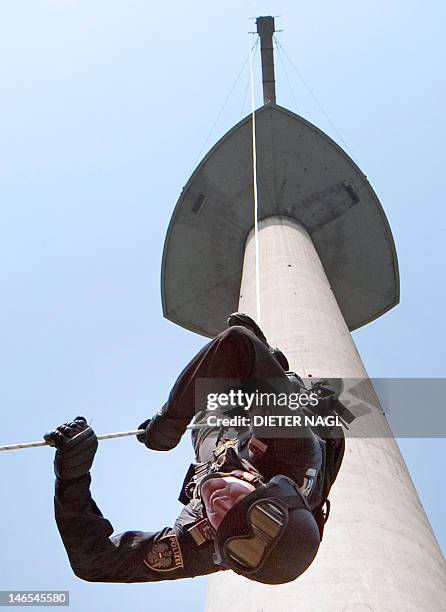 Police officier rappels from the 252-metre high Donauturm during a joint practice drill of WEGA special police and paramedics on June 19, 2012 in...
