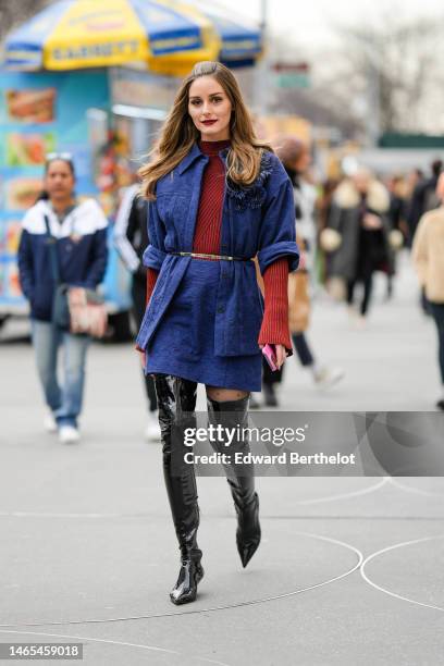 Olivia Palermo wears a red striped print pattern high neck / long sleeves t-shirt, a navy blue embossed pattern jacket, matching navy blue embossed...