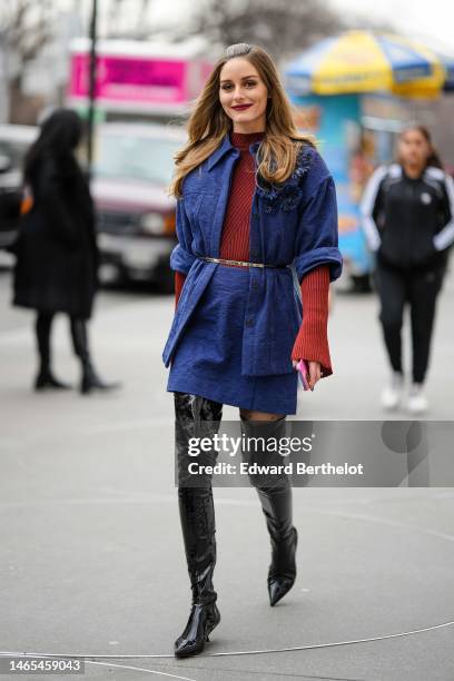 Olivia Palermo wears a red striped print pattern high neck / long sleeves t-shirt, a navy blue embossed pattern jacket, matching navy blue embossed...