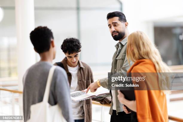 teacher in conversation with high school students - young arabs stock pictures, royalty-free photos & images