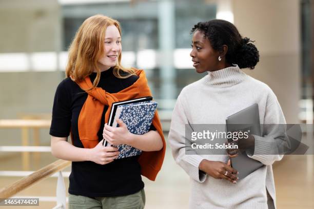 teenage school students walking in hallway - student organization stock pictures, royalty-free photos & images