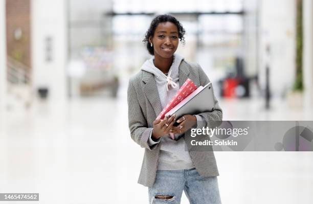 portrait of teenage girl standing in school hallway - school building entrance stock pictures, royalty-free photos & images