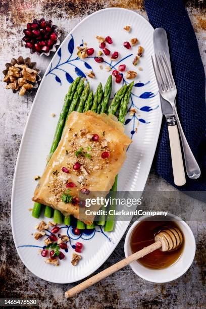 baked feta cheese wrapped in filo pastry with asparagus - portion control stock pictures, royalty-free photos & images