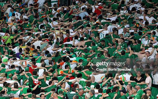 Fans of Ireland do the "Poznan" celebration as they turn around from the action in the stands during the UEFA EURO 2012 group C match between Italy...