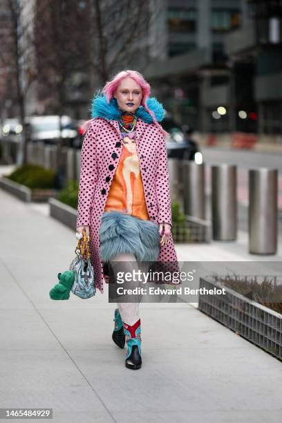 Guest wears a neon orange turtleneck pullover, multicolored large pearls necklaces, a beige and orange print pattern with embroidered large blue fur...