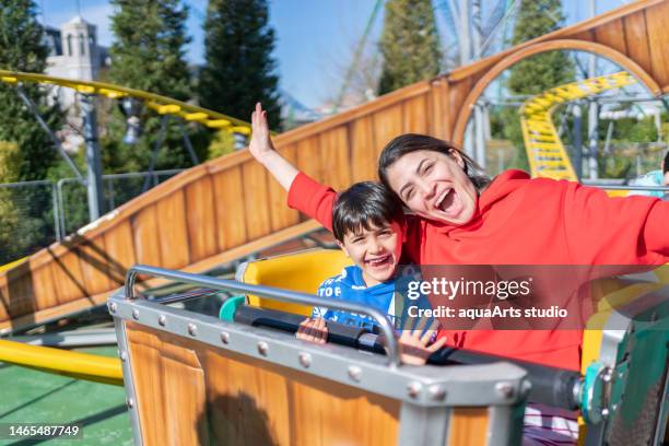 having fun on roller coaster - attractiepark stockfoto's en -beelden