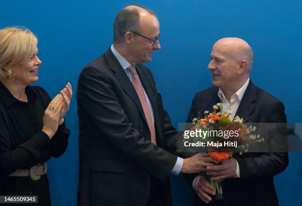 Kai Wegner, lead candidate of the German Christian Democrats in yesterday's Berlin state election redo, is greeted with flowers by CDU head Friedrich...