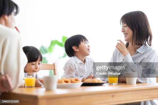 a family eating sweets around the table - japan mom and son stock pictures, royalty-free photos & images