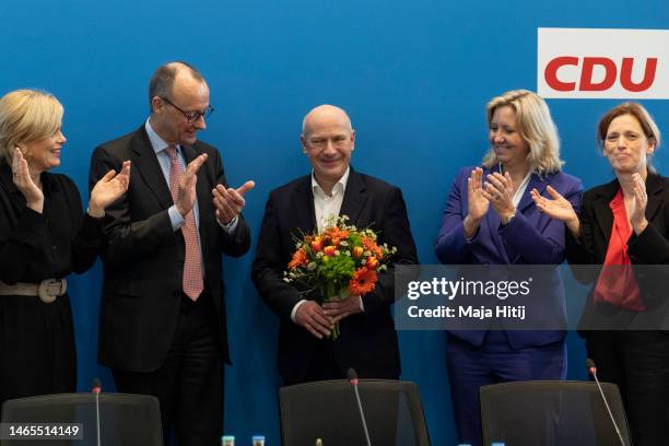 Kai Wegner, lead candidate of the German Christian Democrats in yesterday's Berlin state election redo, is greeted with flowers by CDU head Friedrich...