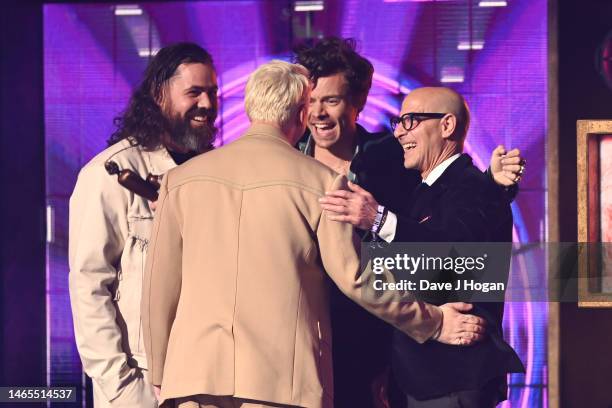 Tyler Johnson, Harry Styles, Kid Harpoon and Stanley Tucci on stage after the presentation of the Album of the Year award during The BRIT Awards 2023...