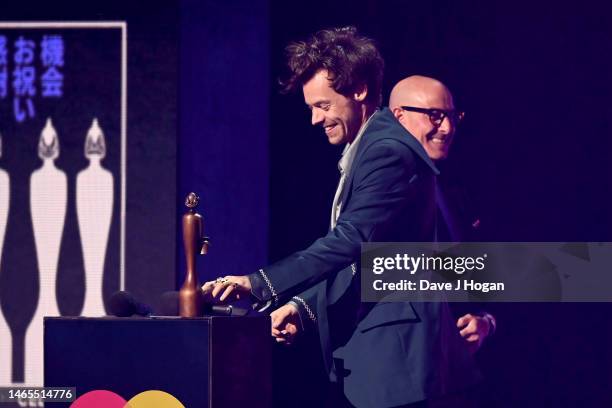 Stanley Tucci presents the award for Mastercard Album of the Year to Harry Styles on stage during The BRIT Awards 2023 at The O2 Arena on February...