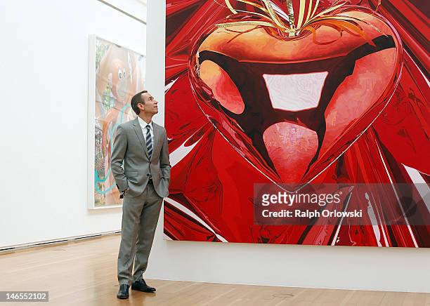 Artist Jeff Koons poses in front of his art work 'Hanging Heart, 1995-1998' during the opening of the exhibition 'Jeff Koons. The Painter & The...