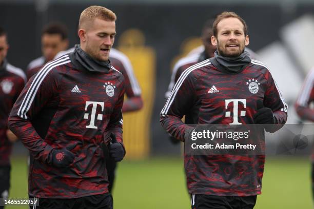 Matthijs de Ligt and Daley Blind of FC Bayern Muenchen jog during a training session ahead of their UEFA Champions League round of 16 match against...