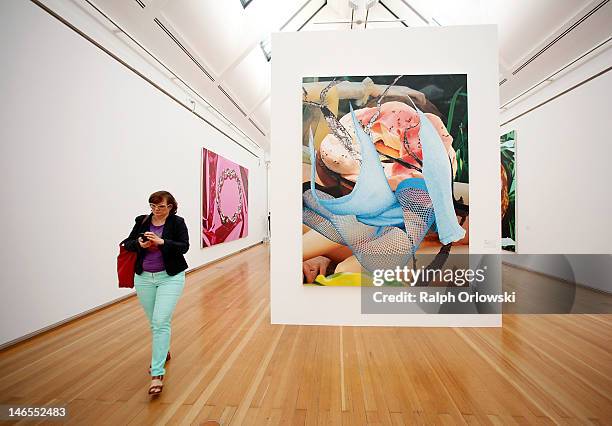 Visitor walks past the art work 'Bagel, 2002' of artist Jeff Koons during the opening of the exhibition 'Jeff Koons. The Painter & The Sculptor' at...