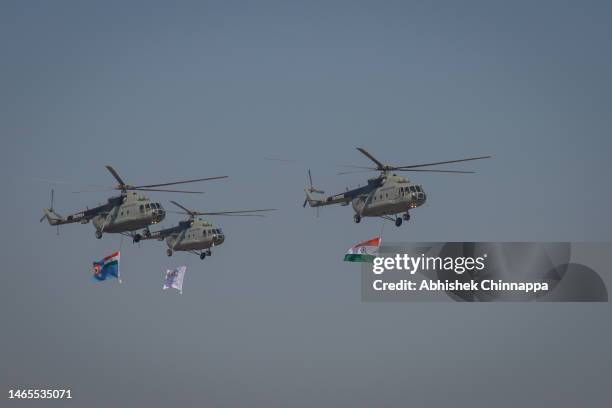 Indian Air Force Mi 17 helicopters perform during the inauguration of the Aero India 2023 at the Yelahanka Air Force Station on February 13, 2023 in...