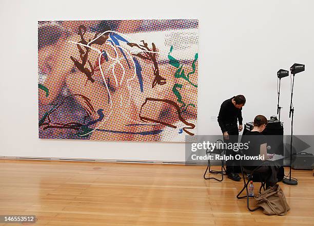 Technicians stand next to the art work 'Couple Landscape, 2009' of artist Jeff Koons during the opening of the exhibition 'Jeff Koons. The Painter &...