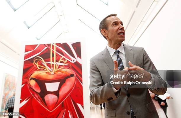Artist Jeff Koons gestures in front of his art work 'Hanging Heart, 1995-1998' during the opening of the exhibition 'Jeff Koons. The Painter & The...