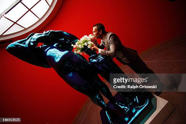Artist Jeff Koons poses next to his art work 'Metallic Venus, 2012' during the opening of the exhibition 'Jeff Koons. The Painter & The Sculptor' at...