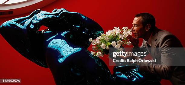 Artist Jeff Koons poses next to his art work 'Metallic Venus, 2012' during the opening of the exhibition 'Jeff Koons. The Painter & The Sculptor' at...