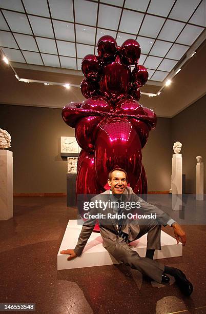 Artist Jeff Koons poses next to his art work 'Balloon Venus, 2012' during the opening of the exhibition 'Jeff Koons. The Painter & The Sculptor' at...