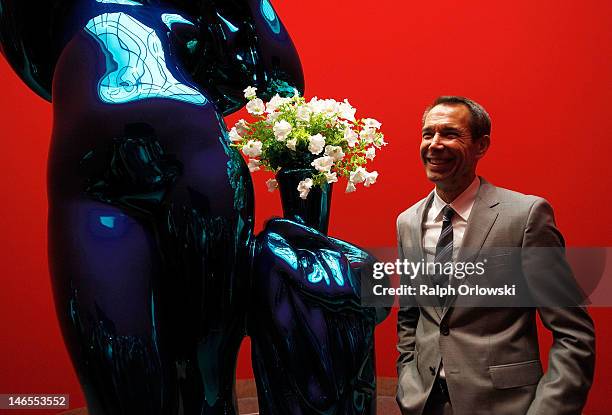 Artist Jeff Koons poses next to his art work 'Metallic Venus, 2012' during the opening of the exhibition 'Jeff Koons. The Painter & The Sculptor' at...