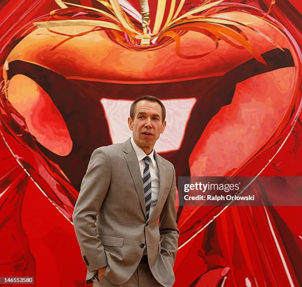 Artist Jeff Koons poses in front of his art work 'Hanging Heart, 1995-1998' during the opening of the exhibition 'Jeff Koons. The Painter & The...