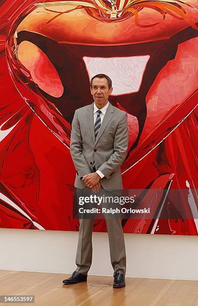 Artist Jeff Koons poses in front of his art work 'Hanging Heart, 1995-1998' during the opening of the exhibition 'Jeff Koons. The Painter & The...