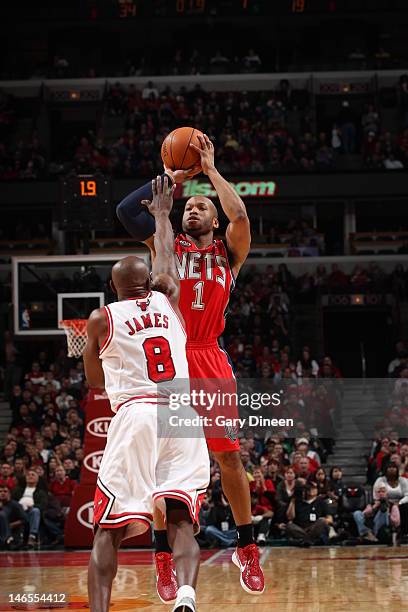 Sundiata Gaines of the New Jersey Nets takes a shot past Mike James of the Chicago Bulls during the game on February 18, 2012 at the United Center in...