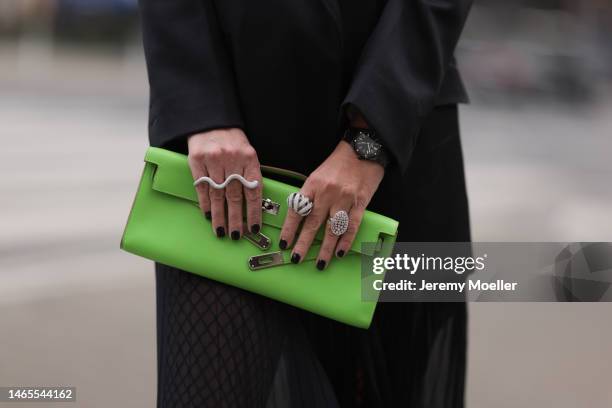 Corina Mihaila Larpin wearing Peter Do black blazer, Dior black bra and shorts, Hermès green leather clutch, YSL plateau black leather boots, Stefere...