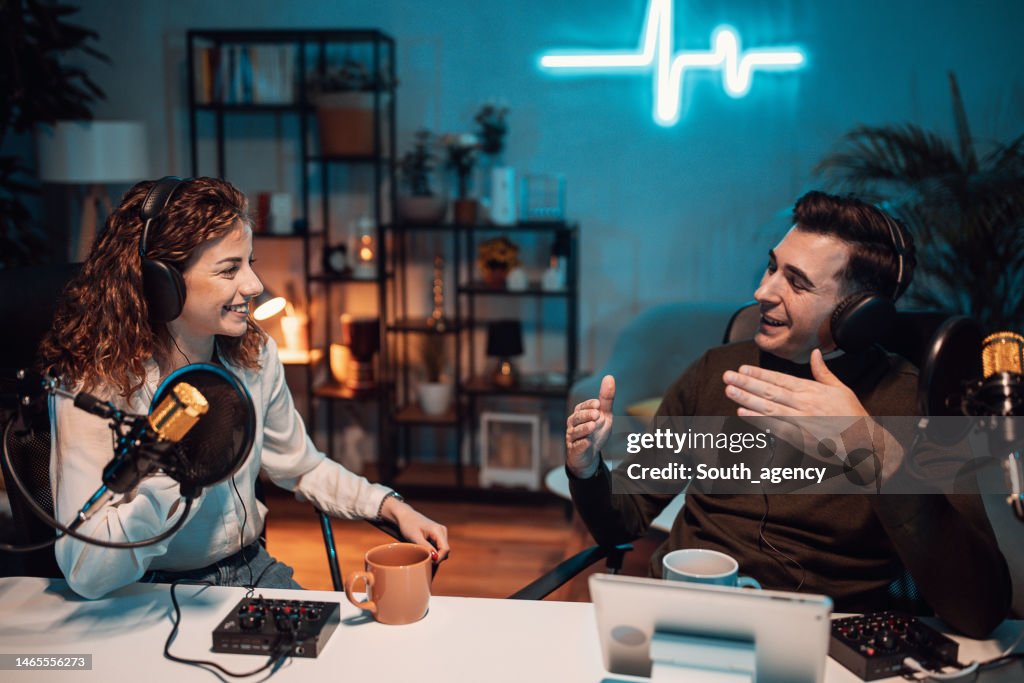 People in the podcast studio talking and recording