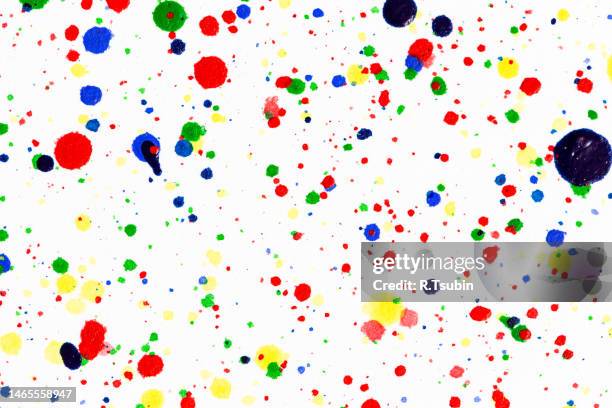colorful ink splashes. paint splatters on bright material. multi color dots. watercolor on white paper. - blob stock pictures, royalty-free photos & images