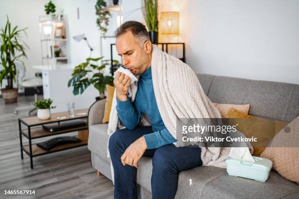 sick man catching seasonal flue - covering cough stock pictures, royalty-free photos & images