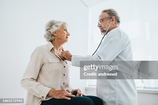 Doctor listening to senior woman patient heartbeat Doctor listening to senior woman patient heartbeat