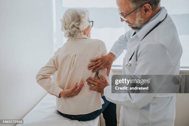 senior patient with back pain - backbone stock pictures, royalty-free photos & images