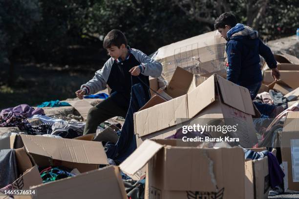 Kids look for suitable clothes among aid in the aftermath of the deadly earthquake on February 13, 2023 in Samandag, Turkey. A 7.8-magnitude...