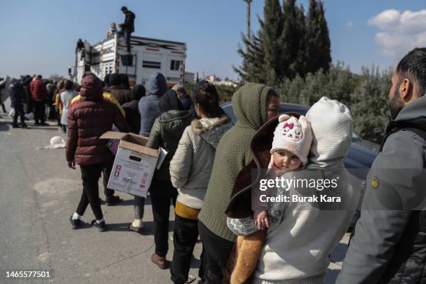 People queue to receive food and goods on February 13, 2023 in Samandag, Turkey. A 7.8-magnitude earthquake hit near Gaziantep, Turkey, in the early...