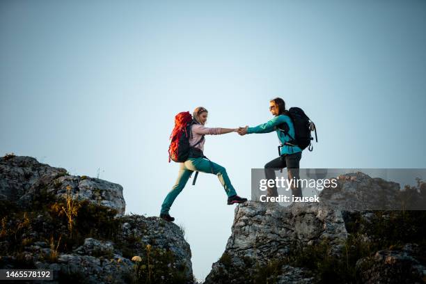 female friends hiking in the mountains - stand by stock pictures, royalty-free photos & images