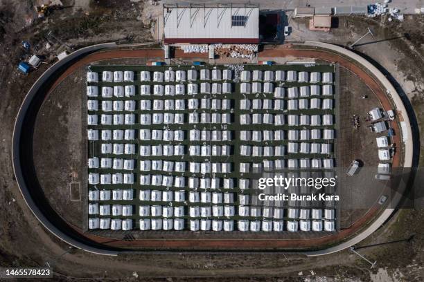 Tents stand at an internal displacement camp at the Samandag Stadium in the aftermath of a deadly earthquake on February 13, 2023 in Samandag,...