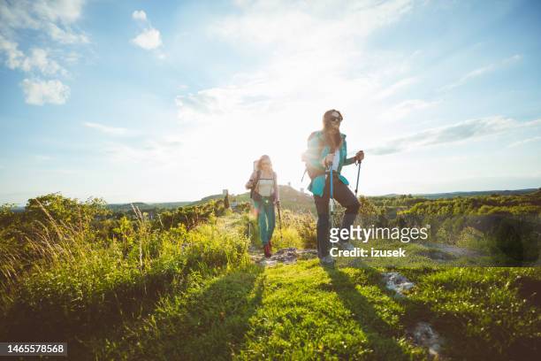 female friends hiking outdoors in nature - summer happiness stock pictures, royalty-free photos & images