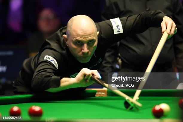 Joe Perry of England plays a shot in the qualifying match against Mark King of England on day one of 2023 Betvictor Welsh Open at Venue Cymru on...