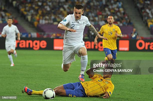 French midfielder Mathieu Debuchy vies with Swedish defender Martin Olsson during the Euro 2012 football championships match Sweden vs France on June...