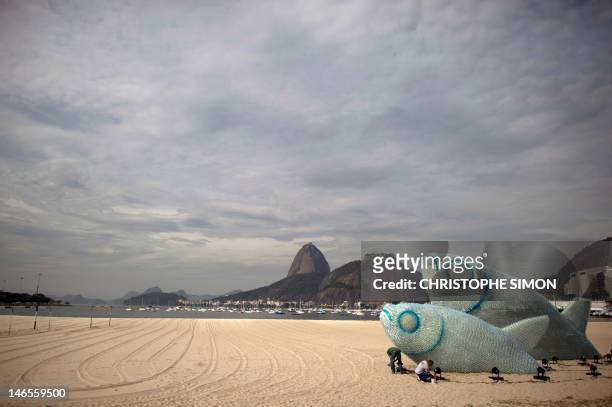 View of an installation made of recycled plastic bottles representing fishes, in Botafogo beach, in Rio de Janeiro, on June 19 in the sidelines of...