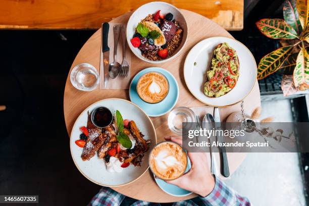 eating breakfast at the cafe, directly above personal perspective view - avocado smoothie stock pictures, royalty-free photos & images